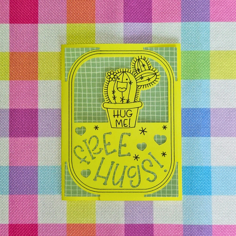 Yellow card with a cactus illustration and 'Hug Me! Free Hugs!' text on a colorful checkered background.