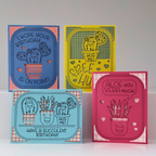 Four colorful greeting cards with succulent-themed designs on a white background