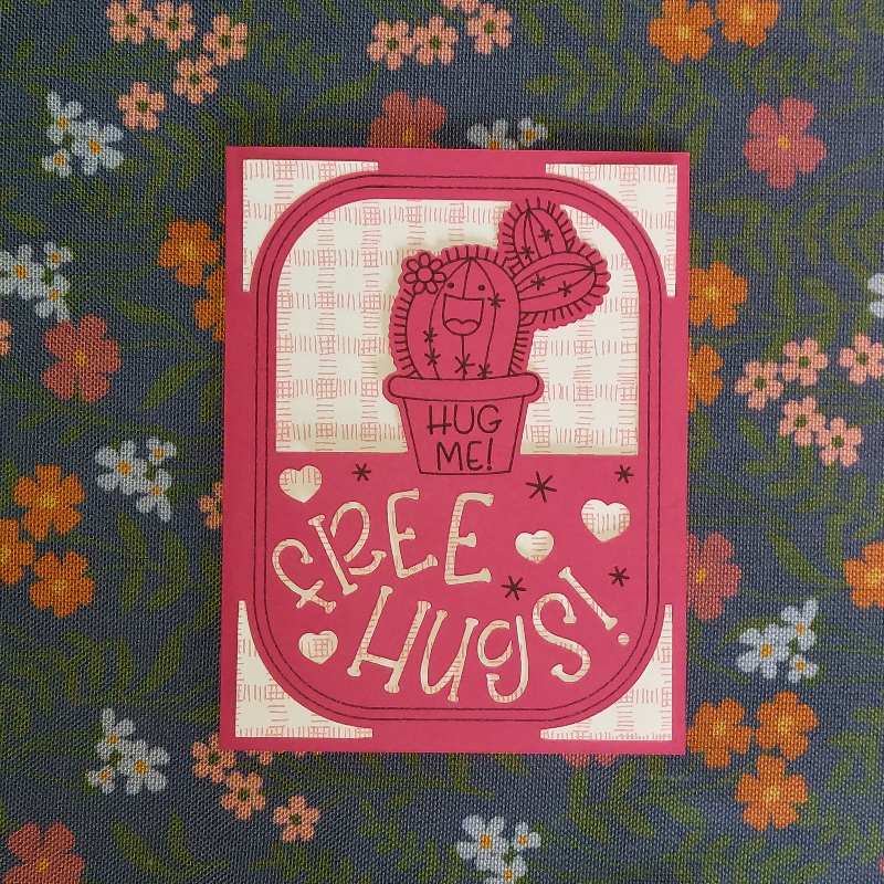 Card with a cactus illustration and 'Hug Me Free Hugs!' text on a floral background