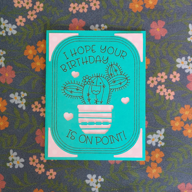 Teal birthday card with cactus illustration on a floral background