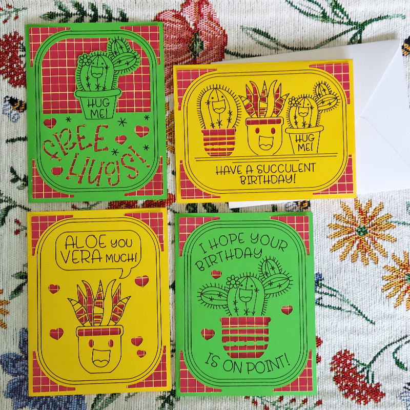 Four colorful greeting cards with succulent designs on a floral background