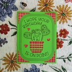 Green birthday card with cactus illustration on a floral background