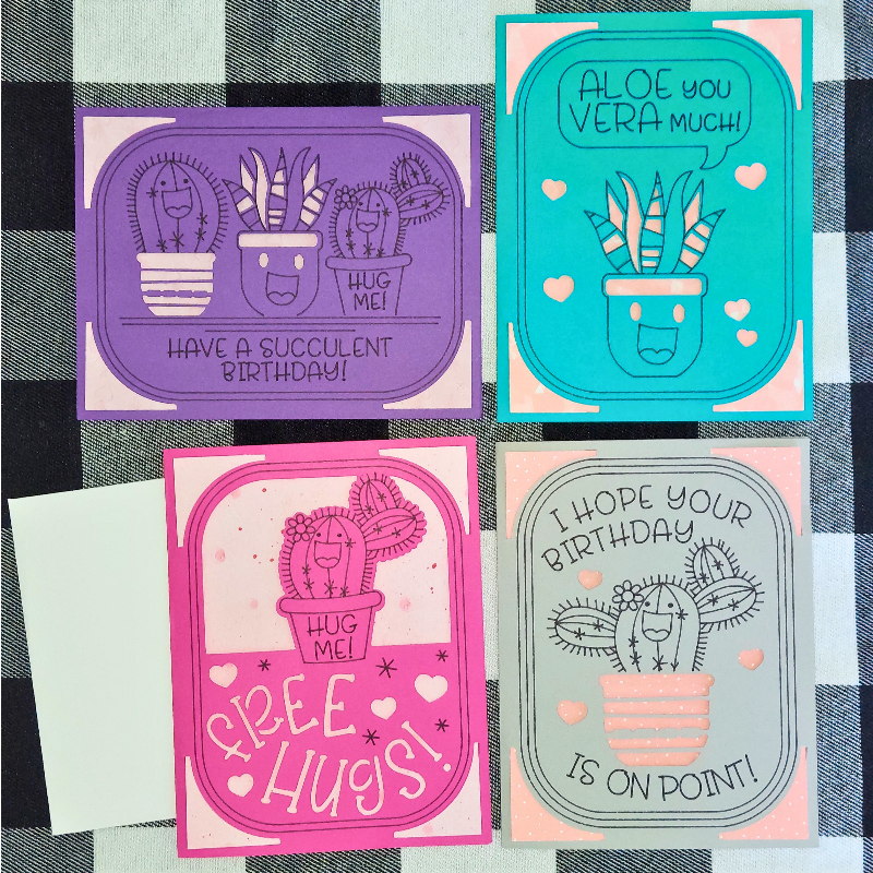 Four cactus-themed greeting cards on a checkered background