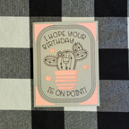 Birthday card with cactus illustration on a checkered fabric background